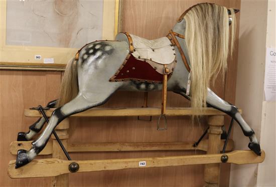 A Lines Limited dapple grey rocking horse on trestle base (restored), 129cm wide